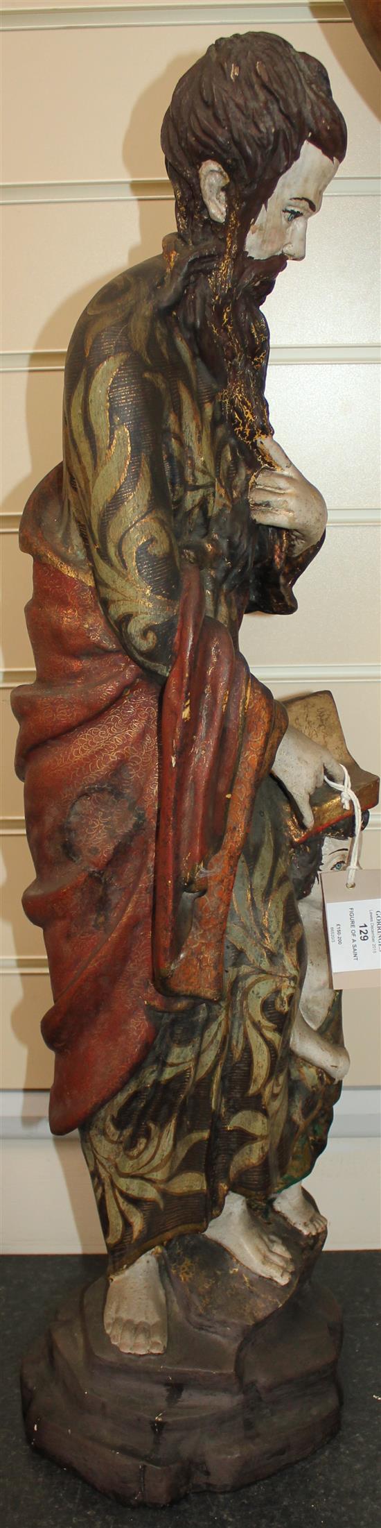 A 20th century carved and polychrome painted figure of a Saint, 31in.